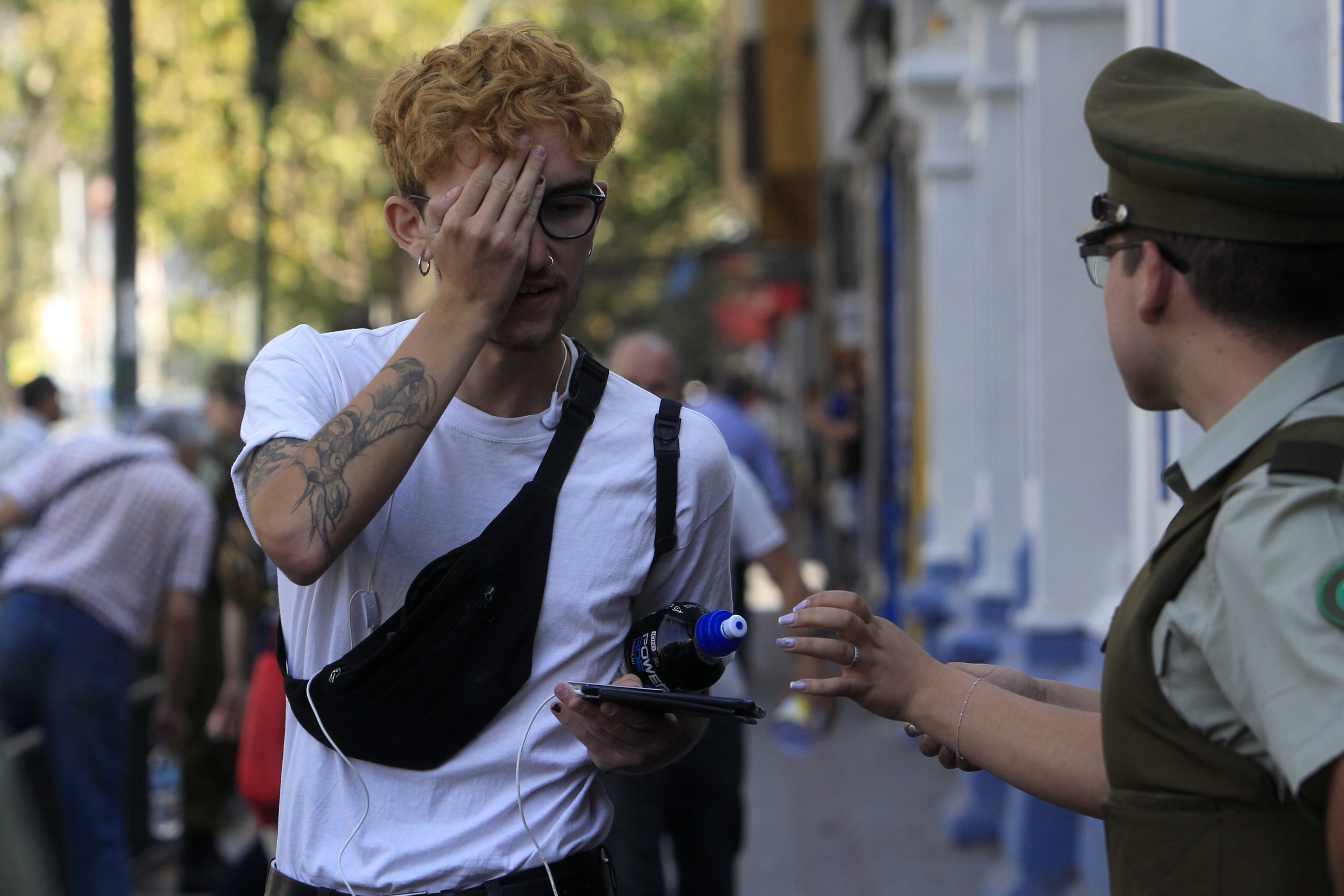 Segundo dia de Rendicion de la PSU en el colegio Republica Argentina, ubicado en calle Vicuna Mackenna. En la imagen un joven se tapa un ojo frente a Carabineros.